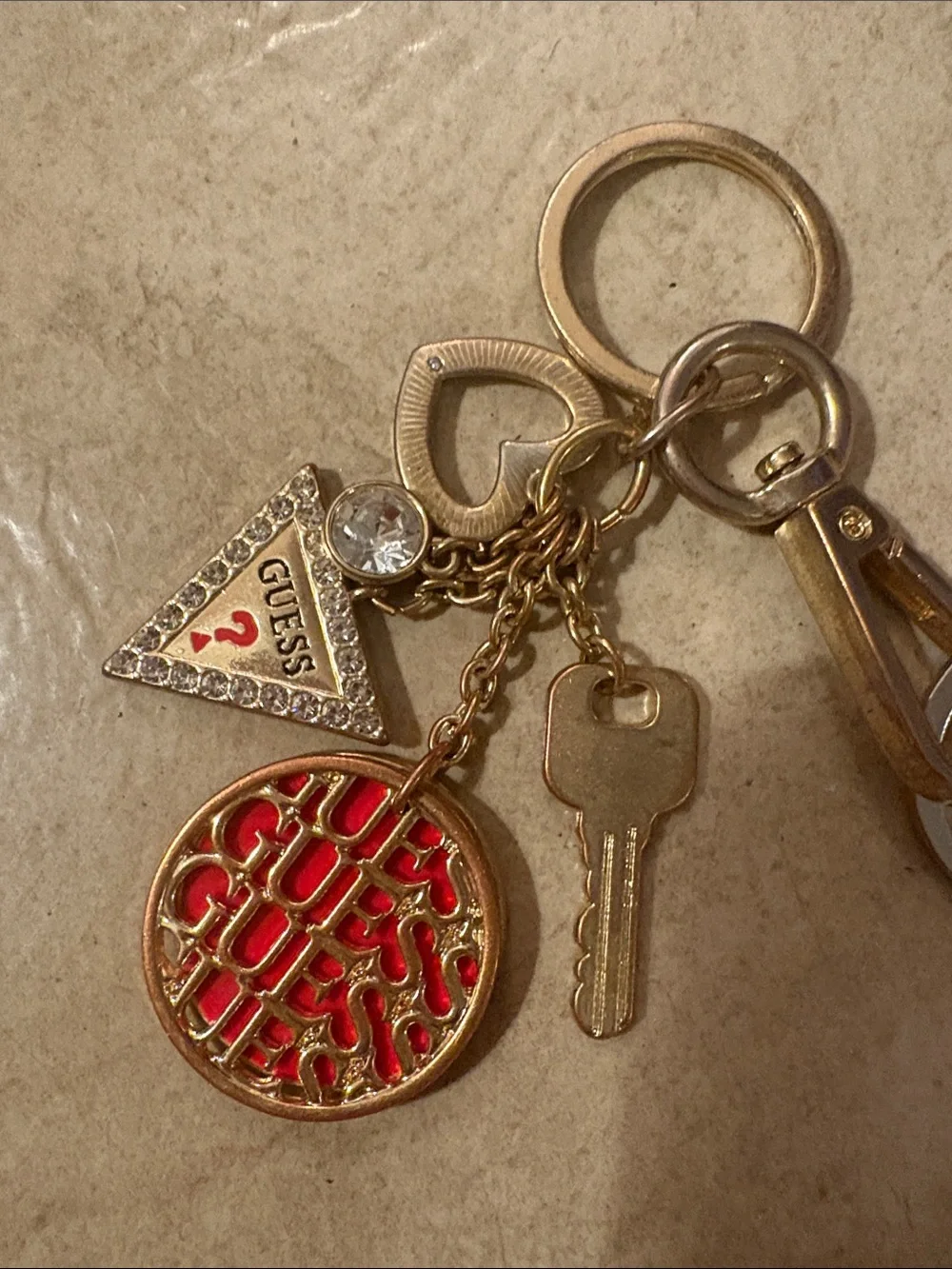 GUESS Gold-Tone Keychain with Red Logo Disc and Triangle Charm